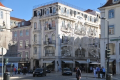 The  turn of the 19th century architecture of the buildings to the south of the Rossio Square. The Baixa Pombaline,  Downtown is a neighborhood in the historic center of Lisbon, Portugal. It consists of the grid of streets north of the Praça do Comércio, roughly between the Cais do Sodré and the Alfama district beneath the Lisbon Castle.