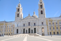 The church, built in white marble, is located in the center of the main façade, symmetrically flanked on both sides by the royal palace.