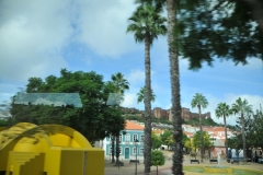 The castle to the left in the photo on top of the hill