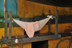 A baby sleeping in a hammack in the market