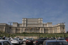 The construction of the Palace began in 1984 and should have been completed in only two years. The term was then extended until 1990, but even now it is not finalized. Only 400 rooms and two meeting rooms are finished and used, out of 1,100 rooms. In the center of the photo is a patio area with  a flag on each side of the patio. The next photo is taken from that patio area. looking out onto the city.