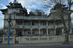 Old grey Soviet block buildings arriving into the town of Constanta on the Black Sea.