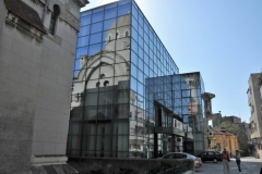 Reflection of the mosque in the glass of the newer building.