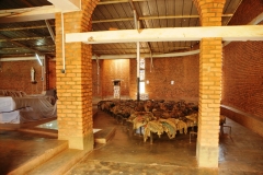 The ceiling of the church shows the bullet holes and the altar cloth is still stained with blood. Most of the remains have been buried but clothing and identity cards are left as you can see in the photo above. The identity cards were what identified people as either Tutsi or Hutu.