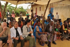 After the fun and dance a few more serious moments. We had purchased, the day before in a market in Kigali, clothing  items for the children of the village and presented the items to the families of the village.