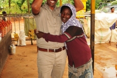Sam with a Jack fruit over head and a friend at a stop we made