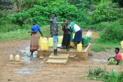 Young girls getting water from the local well for their families