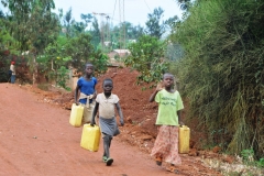 Young girls returning home with water for their families. This is done daily. We are so lucky to have running water in our homes..