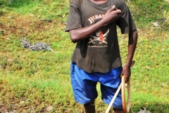 A young boy alongside the road