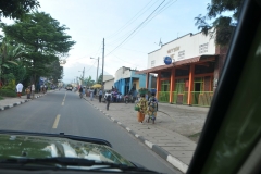 Notice two ladies to the right walking.. fruit on the head and baby on the back of one of the ladies.