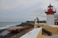 The light house, which is built into the fortress is São Sebastião Lighthouse at the southeastern end of Ana Chaves Bay in São Tomé. The lighthouse is a 18 foot high white round tower with a red lantern. It was built in 1928.