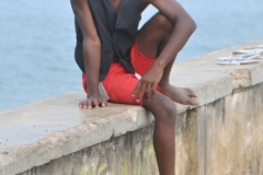 A young teenager gazing off at the ocean.