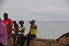A group talking and having fun in the afternoon.  Notice our ship anchored off shore in the distance.