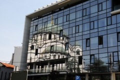 Reflections of the Church of Saint Sava in a neighboring new modeern glass building.