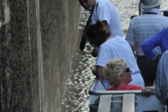 The Captain checking  to see what distance he has from the ship to the wall of the lock.