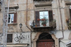 Bicycle hung on the residential building for decoration.