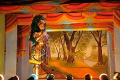 Explaining to us how the puppets function and the care for them over the years.