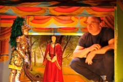 A son explaining what all the generations have brought forward in the puppet world for everyone to enjoy.