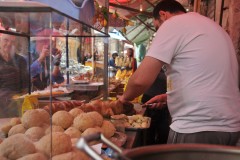 Here a local vendor is preparing some sandwiches for locals to purchase.