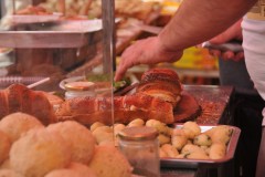 Here he is assembling the cooked intestines and bread for us to sample .