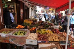 Inspecting local fresh vegetables for sale. We have a chance to mingle with local Sicilians at the market..