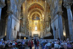 The half dome of the central apse has a colossal half-length figure of Christ, with a seated Virgin and Child below; the other apses have full-length figures of St Peter and St Paul.