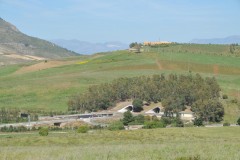 The round circular holes are actually tunnels drilled underground for the highways.