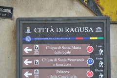 Throughout the city of Ragusa are signs like this telling where important places are to see. Also is the distance inminutes to   see.