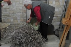 Concetta takes branches  from the  farm's  hills and puts it into the over and starts a fire to bake the bread.