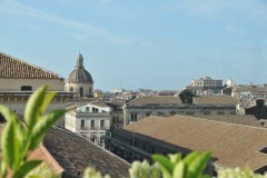 Roof top view of Catania.  Catania is an ancient port city on Sicily's east coast. It sits at the foot of Mt. Etna, an active volcano with trails leading up to the summit.