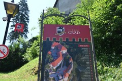 Sign board with a diagram of the Bled Castle on the hill looking down on Lake Bled .
