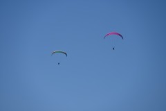 Overhead  parachutes gliding toward earth  passed over us. 