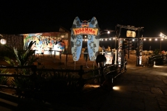 Beach restaurant lighted at night on the ocean. 