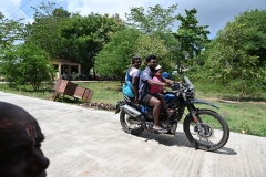 An Indian SUV.. 3 on a motorcycle.