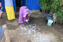 She demonstrated how they make designs in chalk in the concrete in front of her home. 