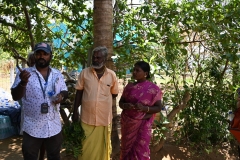 Dennis explaining our visit and he learning about the abilities of this woman to chase off demons with a ceremony. 