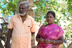 The village leader and the woman with the powers to chase off demons listening to Dennis speak to us.