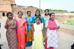 A group of ladies were visiting temple and were  interested in talking with a group of Americans. 