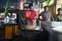 Preparing the Kothu Parotta with rice chicken or vegetable  and spices chopped on the flat grill. It was so good.  on the flat grill.