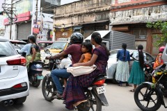 Motorcycle SUV with a family riding.  Only the driver needs a  helmet.