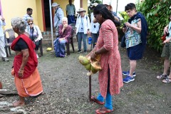 Here she is splitting the coconut for us to sample.