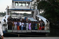 Pedestrians ready to leave the ferry with cars and bicycles to follow. They run every few minutes. 