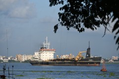 Ship leaving the harbor of Kochi for the open ocean close by. 