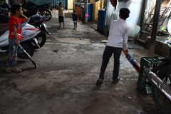 Young boys playing Cricket in the passage ways for recreation. 
