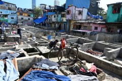  For 18 to 20 hours each day, these workers tirelessly flog, scrub, dye and bleach clothes on concrete wash pens, dry them on ropes, neatly press them and transport the garments to different parts of the city. 