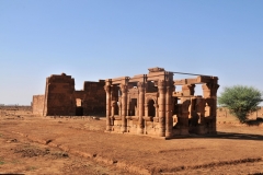 In the foreground is the Roman kiosk is a small temple near the main temple building, which has strong Hellenistic elements. The entrance to the kiosk is Egyptian and is topped by a lintel with a row of sacred ureaus (cobras) but the sides consists of columns with florid Corinthian capitals arched windows in the Roman style. The rear Temple is the Apedemak Temple.