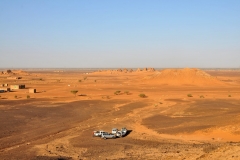 Vehicles in the foreground waiting to take us over to visit The Royal Necropolis of Meroe