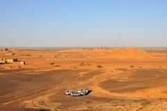 Vehicles in the foreground waiting to take us over to visit The Royal Necropolis of Meroe