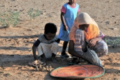 Little one trying to sell replicas of the pyramids. I bought one.