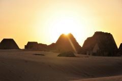 The sand in the foreground looks like a carpet draped over the landscape.